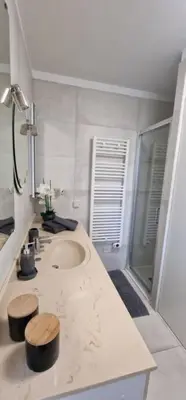 a white bathroom with a sink and a shower at Le Castille - à deux pas des plages in Cannes