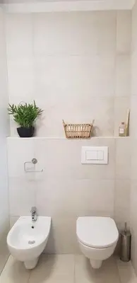 a white bathroom with a toilet and a sink at Le Castille - à deux pas des plages in Cannes