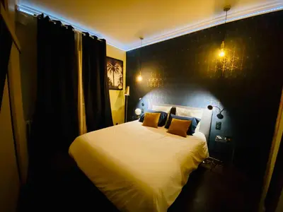 a bedroom with a large white bed with yellow pillows at I Cannes Sleep - Centre ville au calme in Cannes