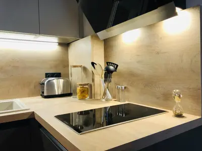 a kitchen with a sink and a counter top at I Cannes Sleep - Centre ville au calme in Cannes