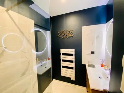a bathroom with a sink and a mirror at I Cannes Sleep - Centre ville au calme in Cannes