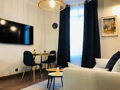 a living room with a couch and a table at I Cannes Sleep - Centre ville au calme in Cannes