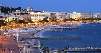 a view of a city with a harbor at night at I Cannes Sleep - Centre ville au calme in Cannes