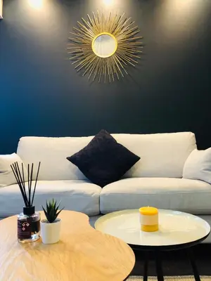 a living room with a white couch and a table at I Cannes Sleep - Centre ville au calme in Cannes