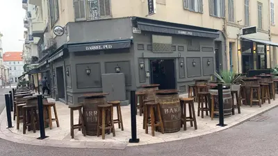 a group of tables and chairs in front of a building at Village Croisette in Cannes