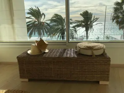 a ottoman with two pillows on it in a room with a window at le panoramer in Cannes