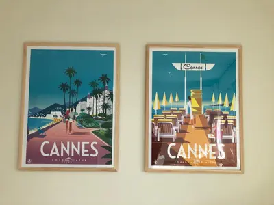 two framed posters hanging on a wall at le panoramer in Cannes