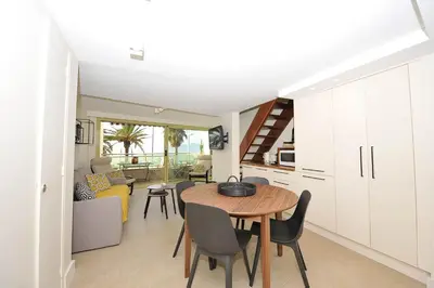 a kitchen and dining room with a table and chairs at le panoramer in Cannes