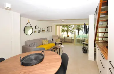 a living room with a table and a couch at le panoramer in Cannes