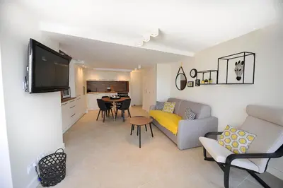 a living room with a couch and a table at le panoramer in Cannes