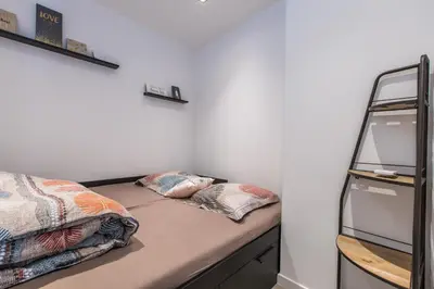a bedroom with two beds and a ladder at LB Vacation Rentals I Admire Panoramic Ocean Views Through Walls of Windows in Cannes