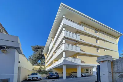 a building with two cars parked in a parking lot at IMMOGROOM- Renovated- Large terrace- AC- Shops- Parking in Cannes