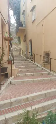 a set of stairs in an alley between two buildings at le suquet quartier historique in Cannes