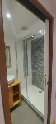 a bathroom with a glass shower and a sink at le suquet quartier historique in Cannes