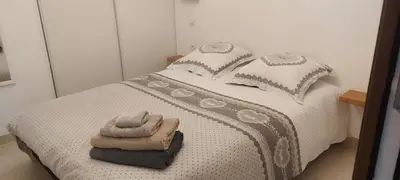 a bedroom with a bed with two towels on it at le suquet quartier historique in Cannes