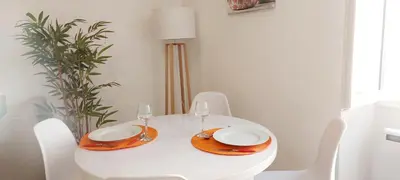 a white table with two plates and glasses on it at le suquet quartier historique in Cannes