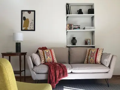 a living room with a gray couch with pillows at LE BAIN DE SOLEIL luxury 2 bedrooms Cannes centre in Cannes