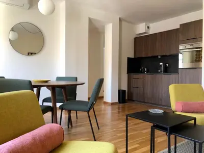 a living room with a table and chairs at LE BAIN DE SOLEIL luxury 2 bedrooms Cannes centre in Cannes