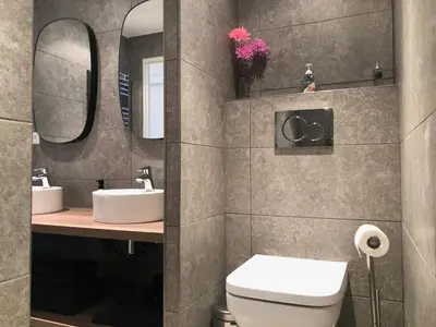 a bathroom with a toilet and a sink and mirrors at LE BAIN DE SOLEIL luxury 2 bedrooms Cannes centre in Cannes