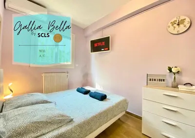 a bedroom with a bed and a clock on the wall at Gallia Bella By SCLS Locations in Cannes