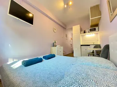 a bedroom with a large blue bed in a room at Gallia Bella By SCLS Locations in Cannes