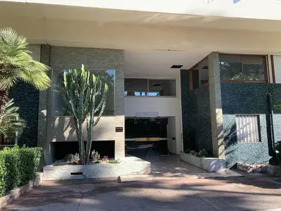 a building with a palm tree in front of it at Gallia Bella By SCLS Locations in Cannes