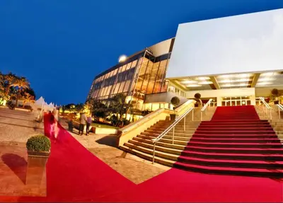 a red carpeted staircase to a building with people on it at Gallia Bella By SCLS Locations in Cannes