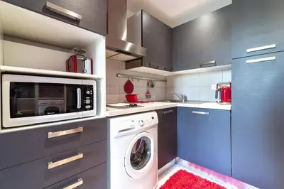 a kitchen with a washer and a washing machine at Beautiful modern apartment in the heart of Cannes in Cannes