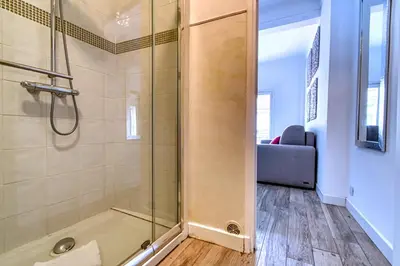 a bathroom with a shower with a glass door at Romantic and new apartment in the famous Rue Meynadier in the supercentre of Cannes in Cannes
