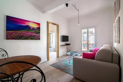 a living room with a couch and a table at Romantic and new apartment in the famous Rue Meynadier in the supercentre of Cannes in Cannes