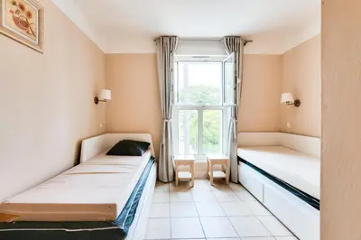 a room with two beds and a window at Résidence Cannes Villa Francia - maeva Home - Appartement climatisé 3 pièces 4 personnes - Prestige - super Home MAE-6737 in Cannes