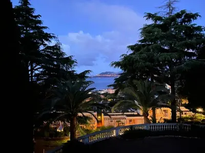 a view of the ocean from a resort at night at Résidence Cannes Villa Francia - maeva Home - Appartement climatisé 3 pièces 4 personnes - Prestige - super Home MAE-6737 in Cannes