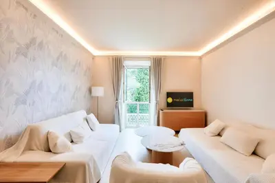 a living room with two white couches and a tv at Résidence Cannes Villa Francia - maeva Home - Appartement climatisé 3 pièces 4 personnes - Prestige - super Home MAE-6737 in Cannes