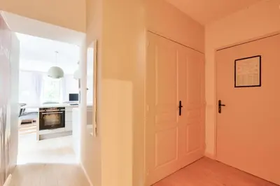 a hallway with a white door and a kitchen at Résidence Cannes Villa Francia - maeva Home - Appartement climatisé 3 pièces 4 personnes - Prestige - super Home MAE-6737 in Cannes