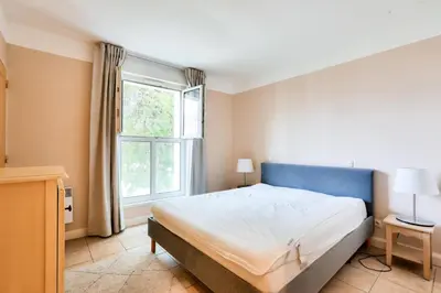 a bedroom with a large bed and a window at Résidence Cannes Villa Francia - maeva Home - Appartement climatisé 3 pièces 4 personnes - Prestige - super Home MAE-6737 in Cannes