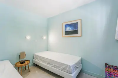 a bedroom with a bed and a picture on the wall at Résidence Cannes Villa Francia - maeva Home - Appartement design 2 pièces 3 personnes avec vue mer - Prestige - Super Home MAE-4317 in Cannes