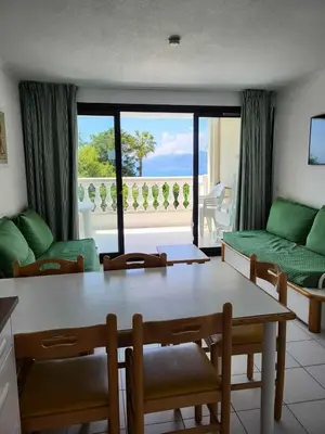 a living room with a table and a view of the ocean at Résidence Cannes Villa Francia - maeva Home - Appartement 3 pièces 4 personnes - Confort MAE-5666 in Cannes
