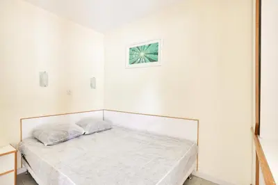 a bed in a white room with a picture on the wall at Résidence Cannes Villa Francia - maeva Home - Appartement 2 pièces 4 personnes - Confort MAE-1762 in Cannes