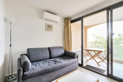 a living room with a couch and a balcony at Résidence Cannes Villa Francia - maeva Home - Appartement 2 pièces 4 personnes - Confort MAE-1762 in Cannes