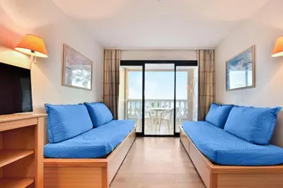 a living room with blue couches and a television at Résidence Cannes Verrerie - maeva Home - 2 Pièces 5 Personnes Confort MAE-3572 in Cannes