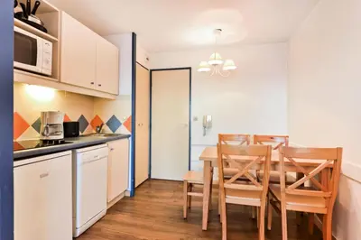 a kitchen and dining room with a table and chairs at Résidence Cannes Verrerie - maeva Home - 2 Pièces 5 Personnes Confort MAE-3572 in Cannes