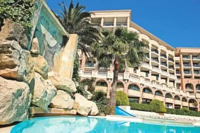 a hotel with a swimming pool in front of a building at Résidence Cannes Verrerie - maeva Home - 2 Pièces 5 Personnes Confort MAE-3572 in Cannes