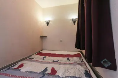 a small room with a bed with a blanket on it at Résidence Cannes Verrerie - maeva Home - Studio 5 personnes Selection MAE-7337 in Cannes