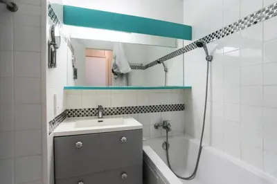 a bathroom with a sink and a shower with a mirror at Résidence Cannes Verrerie - maeva Home - Studio 5 personnes Selection MAE-7337 in Cannes