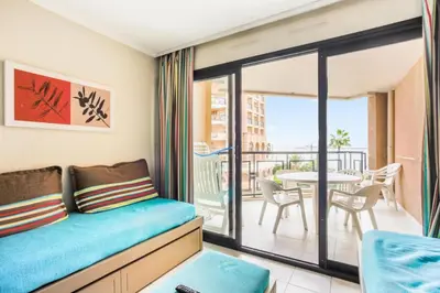 a room with a couch and a balcony with a table at Résidence Cannes Verrerie - maeva Home - Appartement 3 Pièces 6 Personnes - Selection MAE-0305 in Cannes