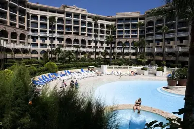 a large building with a swimming pool in front of a building at Résidence Cannes Verrerie - maeva Home - Appartement 3 Pièces 6 Personnes - Selection MAE-0305 in Cannes
