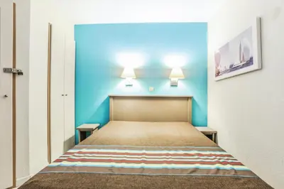 a bed in a room with a blue wall at Résidence Cannes Verrerie - maeva Home - Appartement 3 Pièces 6 Personnes - Selection MAE-0305 in Cannes