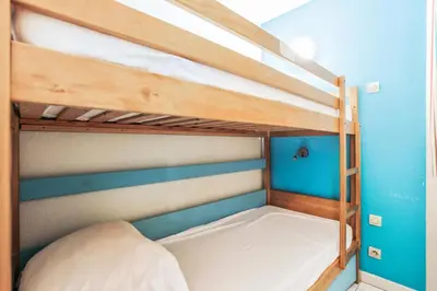two bunk beds in a room with blue walls at Résidence Cannes Verrerie - maeva Home - Appartement 3 Pièces 6 Personnes - Selection MAE-0305 in Cannes