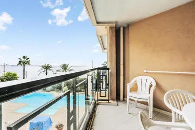 a balcony with a view of a pool and chairs at Résidence Cannes Verrerie - maeva Home - Appartement 3 Pièces 6 Personnes - Selection MAE-0305 in Cannes