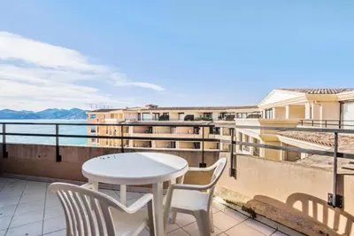 a balcony with a table and chairs and a view of the water at Résidence Cannes Verrerie - maeva Home - Appartement 3 Pièces 6 Personnes - Sélection MAE-4213 in Cannes